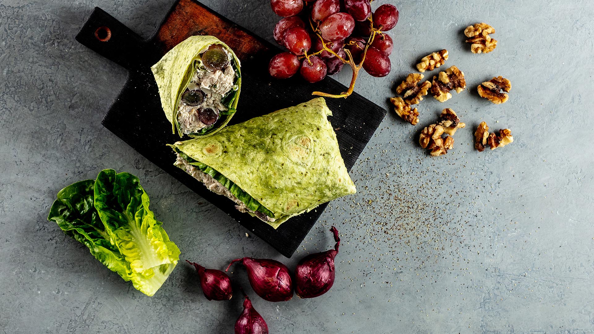 low fat chicken salad spinach wrap on cutting board